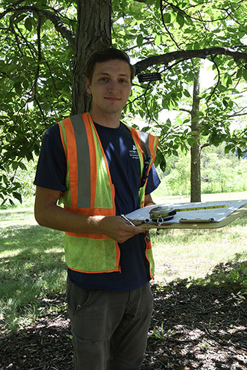 Connor Hennen measures trees at the Arboretum 