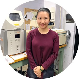 Portrait of Qian Tang standing in a lab.