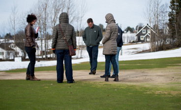 Examining winter damage on a golf green in Norway.